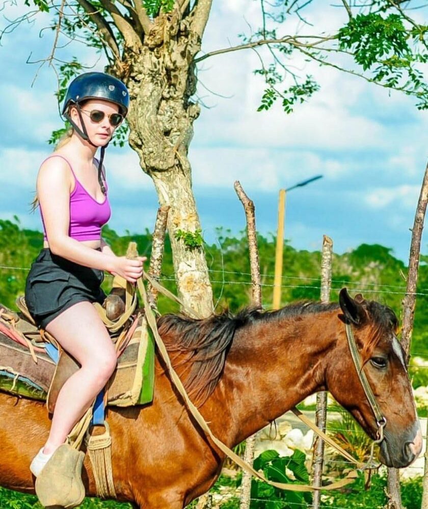 Woman horseback riding on tropical trail at Punta Cana tour operator adventure activity