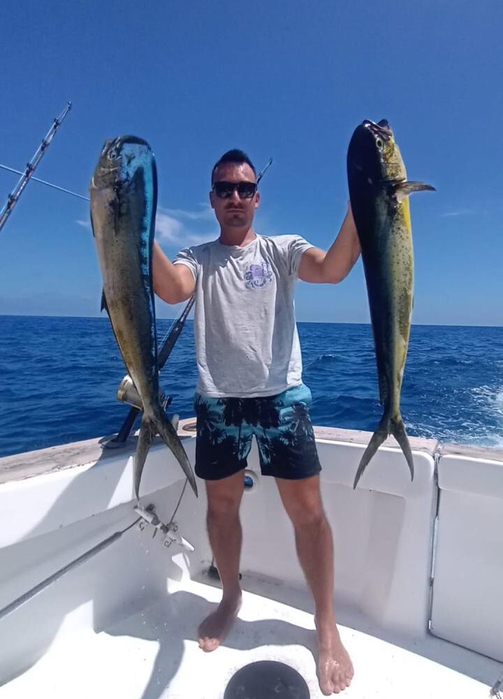 Successful deep sea fishing catch on taxiboat Punta Cana tour with two large mahi-mahi fish