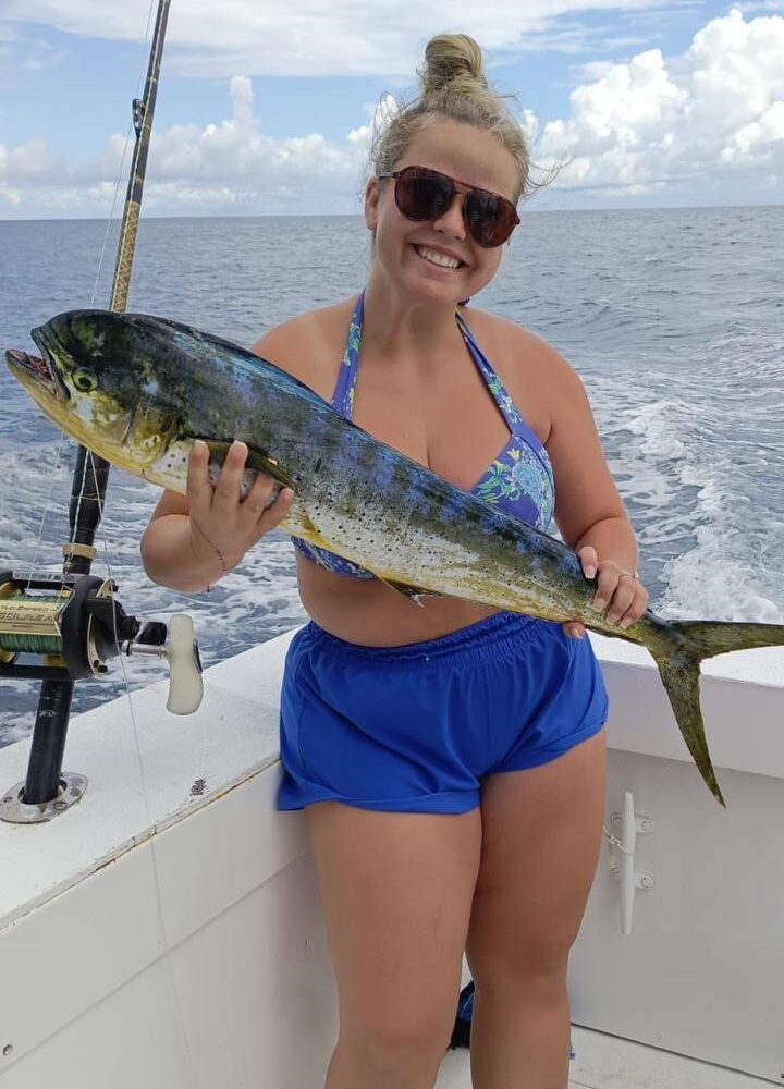 Happy tourist holding mahi-mahi fish caught on taxiboat Punta Cana fishing tour