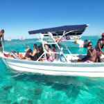 Taxiboat Punta Cana tour with tourists in turquoise Caribbean waters, professional boat service for best Punta Cana tours