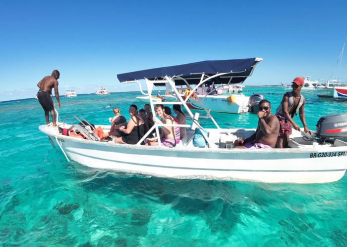 Taxiboat Punta Cana tour with tourists in turquoise Caribbean waters, professional boat service for best Punta Cana tours