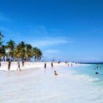 Punta Cana taxiboat beach destination with turquoise waters, white sand, and palm trees