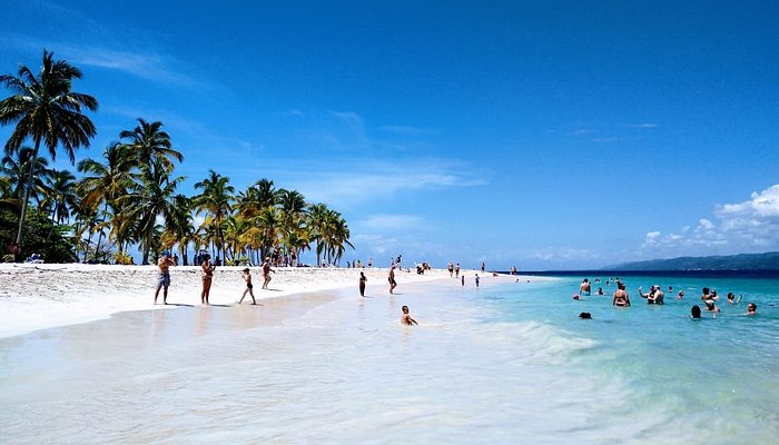 Punta Cana taxiboat beach destination with turquoise waters, white sand, and palm trees